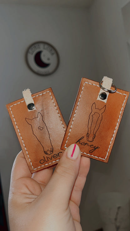 two handmade leather keychain with custom horse silhouettes and their names laser engraved 